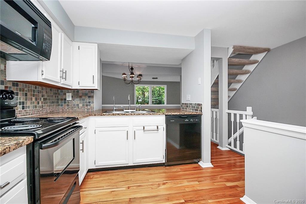 1231 Scaleybark Road, Unit C Charlotte, NC 28209 - Photo 10 of 36 a kitchen with stainless steel appliances granite countertop a stove and a microwave