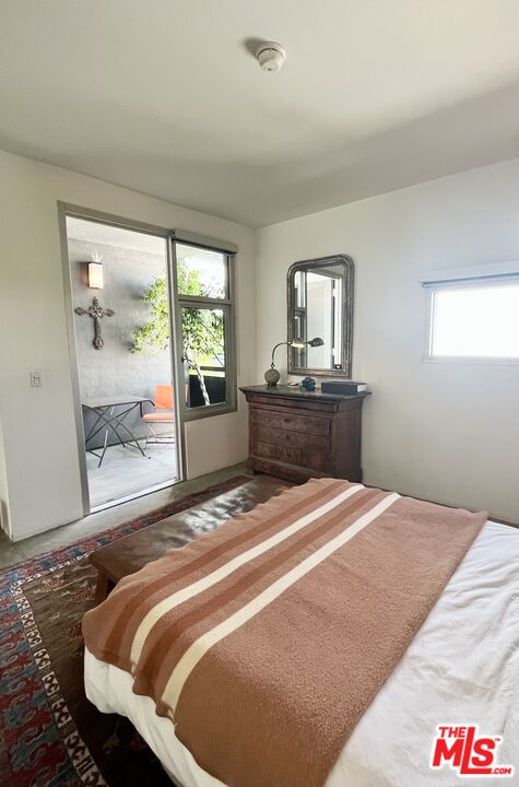 4111 Sunset Boulevard, Unit 332 Los Angeles, CA 90029 - Photo 15 of 17 a bedroom with a bed and wooden floor