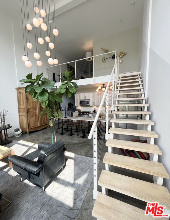4111 Sunset Boulevard, Unit 332 Los Angeles, CA 90029 - Photo 5 of 17 a living room with lots of furniture and a chandelier