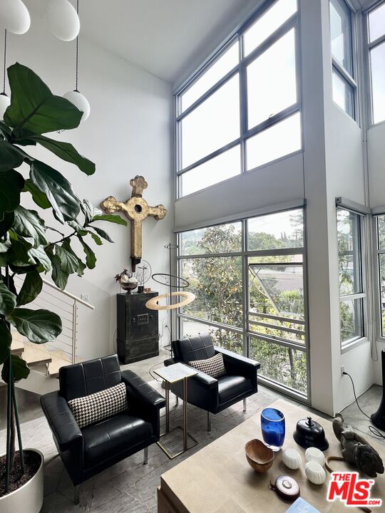 4111 Sunset Boulevard, Unit 332 Los Angeles, CA 90029 - Photo 6 of 17 a living room with furniture and a floor to ceiling window