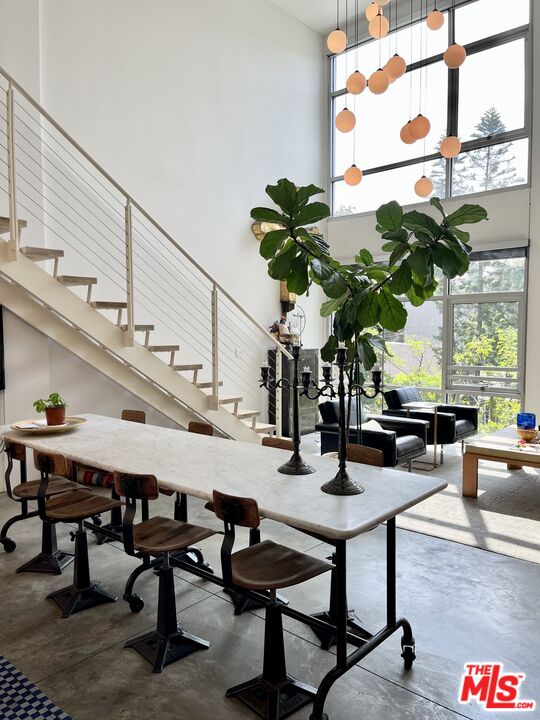 4111 Sunset Boulevard, Unit 332 Los Angeles, CA 90029 - Photo 7 of 17 a dining room with furniture and wooden floor