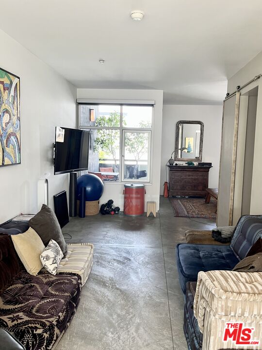 4111 Sunset Boulevard, Unit 332 Los Angeles, CA 90029 - Photo 10 of 17 a living room with furniture and a flat screen tv