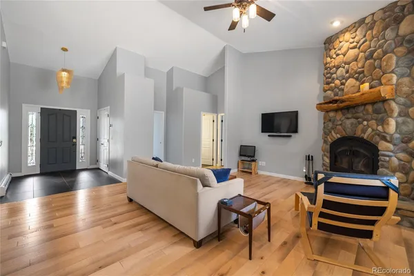 a living room with furniture a fireplace and a flat screen tv