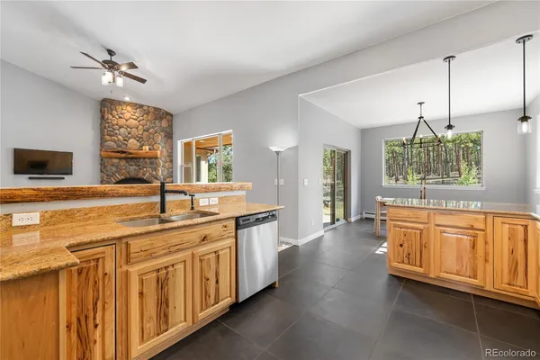 a kitchen with stainless steel appliances granite countertop a sink and cabinets