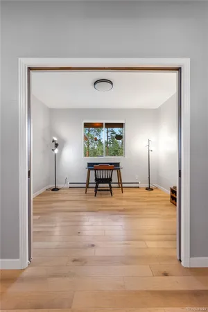 a view of a room with wooden floor and window