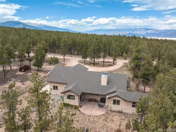 an aerial view of a house with a yard