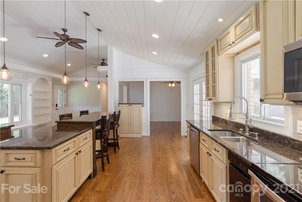 160 Cold Springs Road Hendersonville, NC 28792 - Photo 11 of 26 a kitchen with granite countertop a sink a counter top space appliances and cabinets