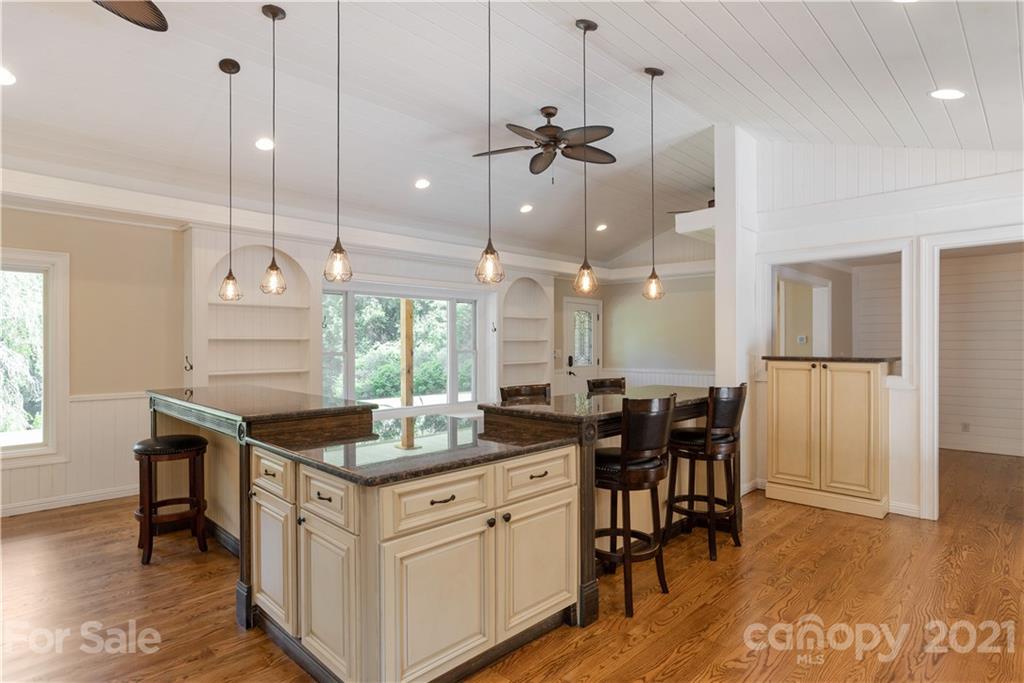 160 Cold Springs Road Hendersonville, NC 28792 - Photo 12 of 26 a kitchen with center island table and chairs