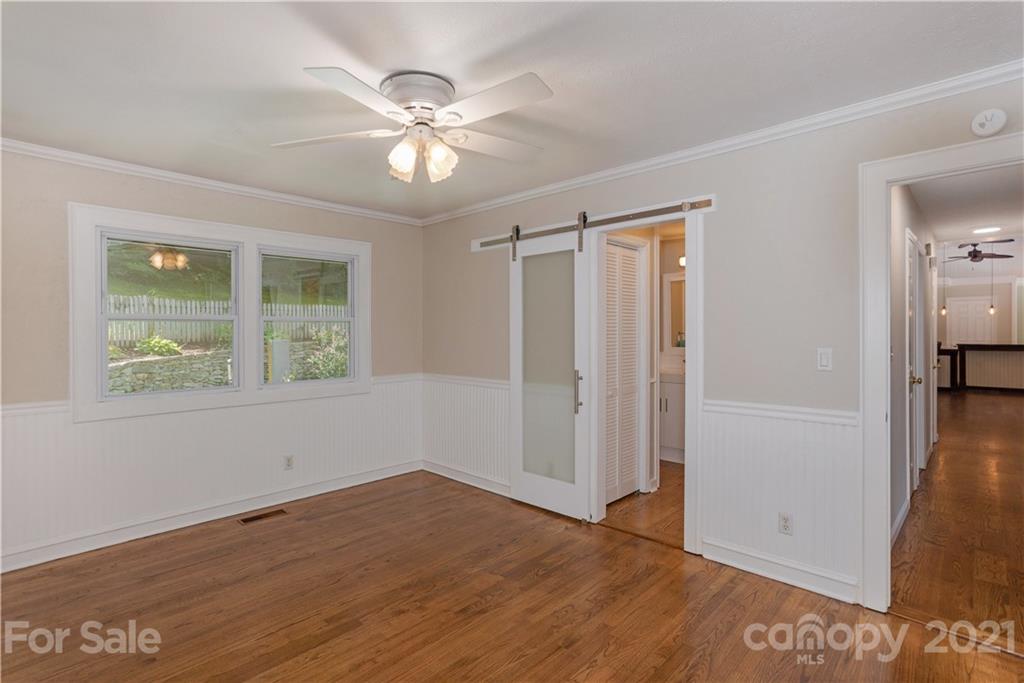 160 Cold Springs Road Hendersonville, NC 28792 - Photo 14 of 26 a view of an empty room with wooden floor and a window