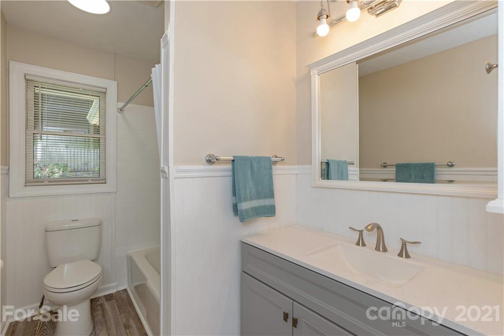 160 Cold Springs Road Hendersonville, NC 28792 - Photo 18 of 26 a bathroom with a granite countertop toilet sink and mirror