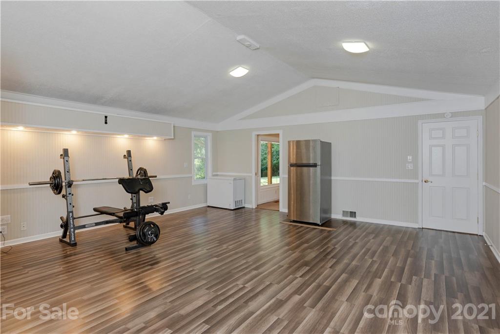 160 Cold Springs Road Hendersonville, NC 28792 - Photo 20 of 26 a view of a room with gym equipment and wooden floor