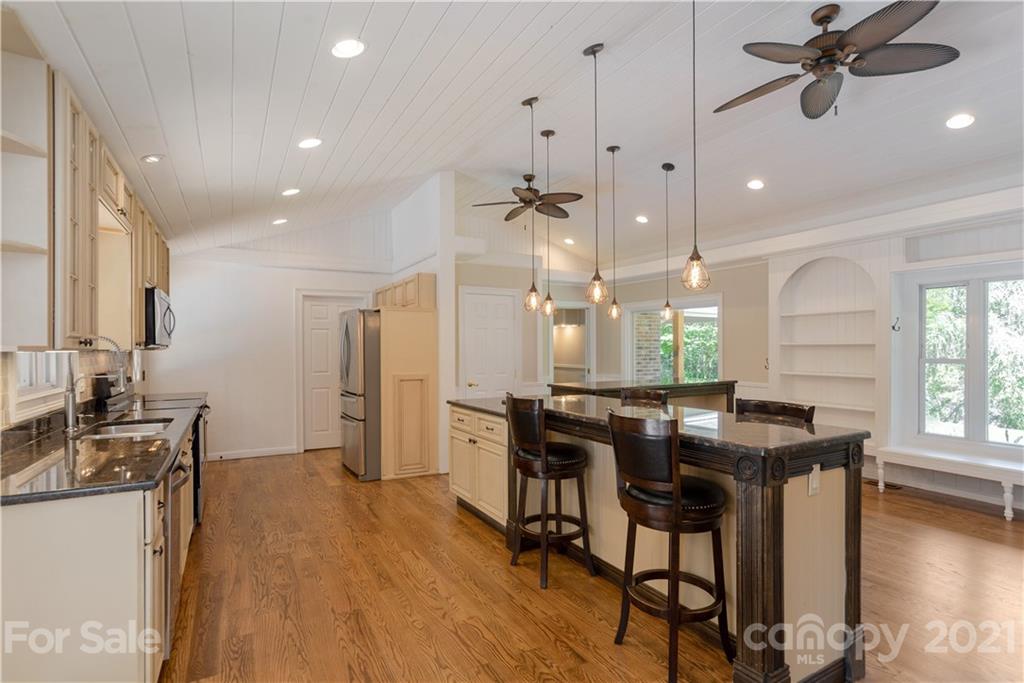160 Cold Springs Road Hendersonville, NC 28792 - Photo 7 of 26 a kitchen with stainless steel appliances kitchen island granite countertop a table chairs refrigerator and sink