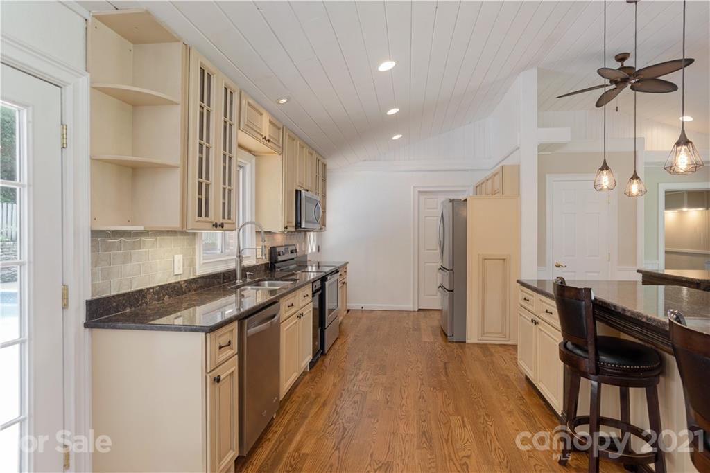 160 Cold Springs Road Hendersonville, NC 28792 - Photo 8 of 26 a kitchen with granite countertop a sink appliances and cabinets