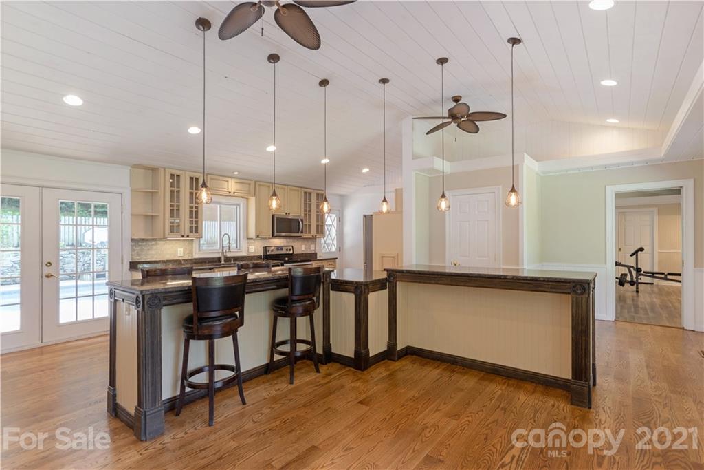160 Cold Springs Road Hendersonville, NC 28792 - Photo 9 of 26 a view of a kitchen with kitchen island stainless steel appliances refrigerator stove dining table and chairs