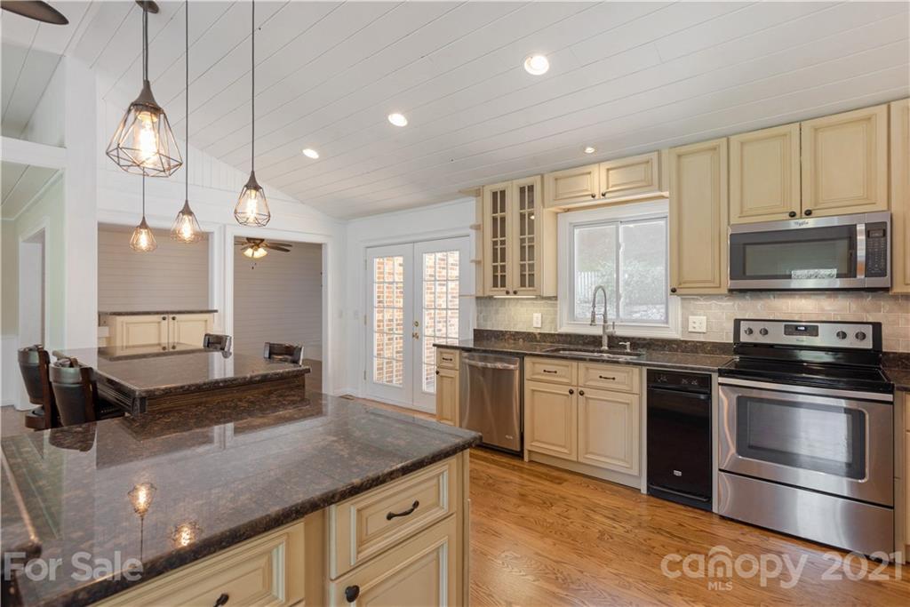 160 Cold Springs Road Hendersonville, NC 28792 - Photo 10 of 26 a large kitchen with granite countertop a stove and a sink