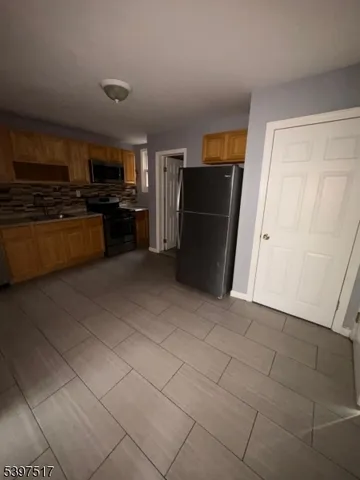 a kitchen with stainless steel appliances a refrigerator and a stove top oven