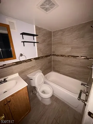 a bathroom with a sink a toilet and a tub