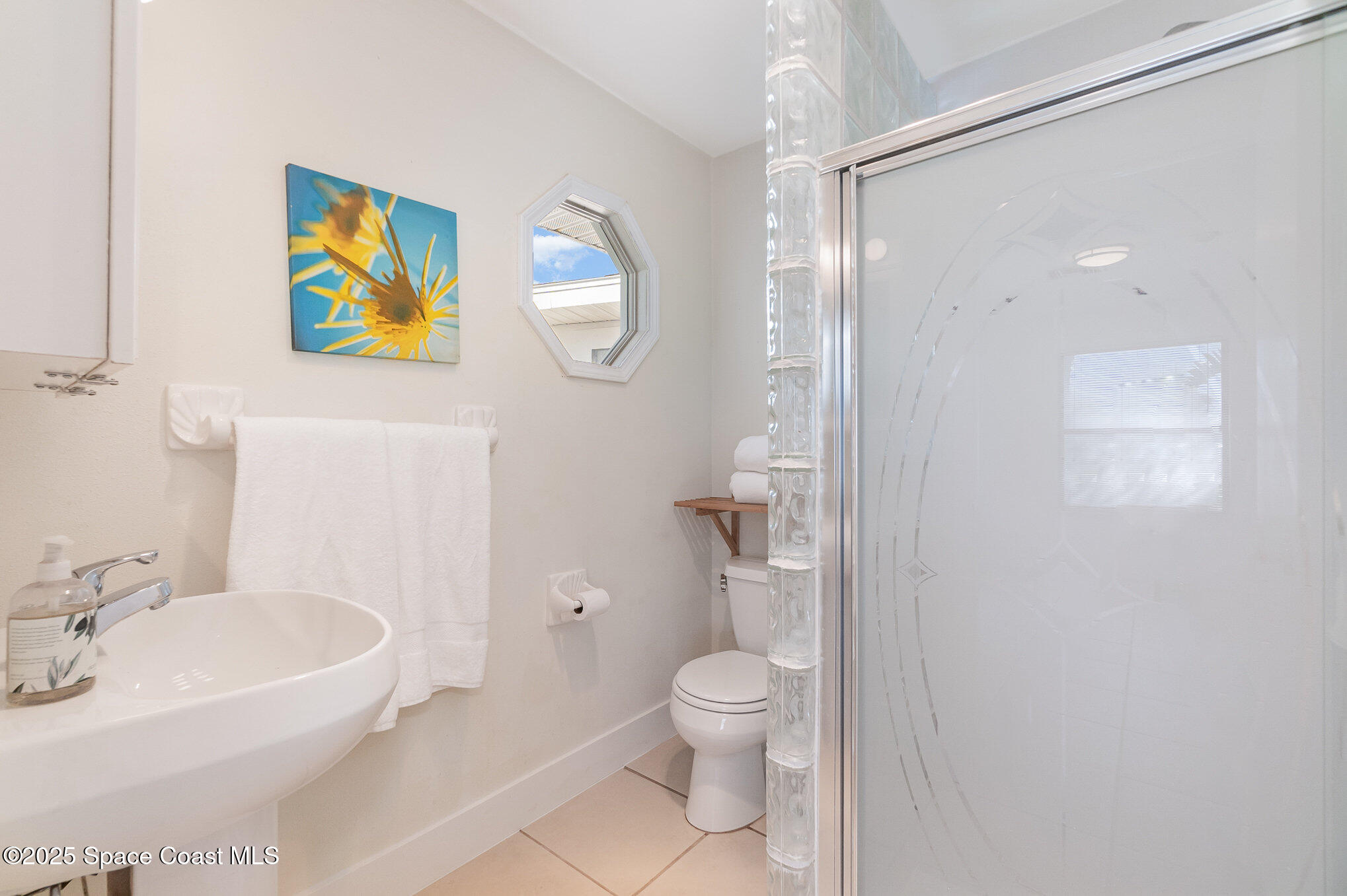 1905 Redwood Avenue Melbourne Beach, FL 32951 - Photo 13 of 15 a bathroom with a sink and a mirror