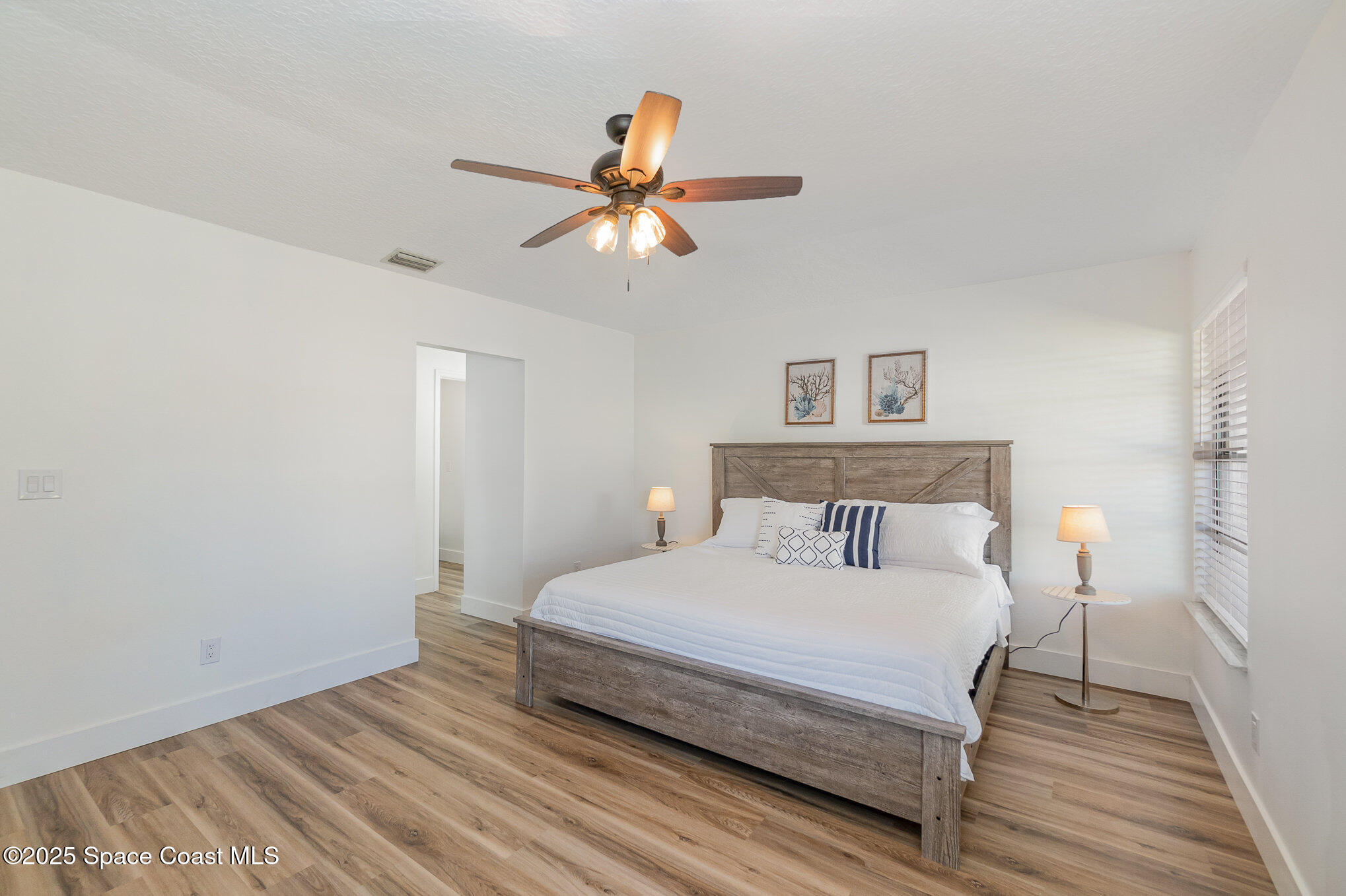 1905 Redwood Avenue Melbourne Beach, FL 32951 - Photo 4 of 15 a bedroom with a bed and a chandelier