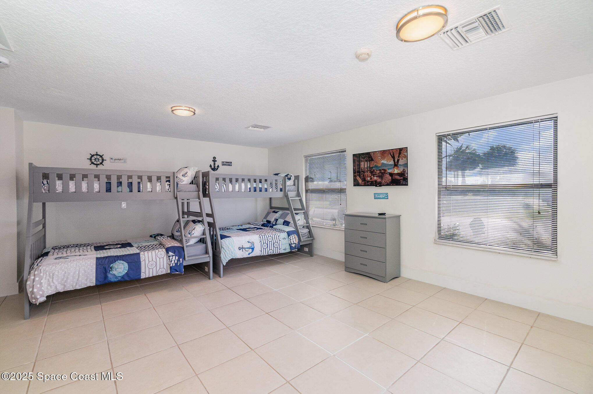 1905 Redwood Avenue Melbourne Beach, FL 32951 - Photo 7 of 15 a bedroom with furniture and a flat screen tv