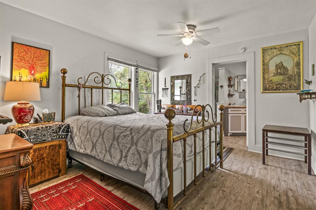 103 South Sun Camp Road White Oak, TX 75693 - Photo 27 of 40 a bed room with a bed and a chandelier