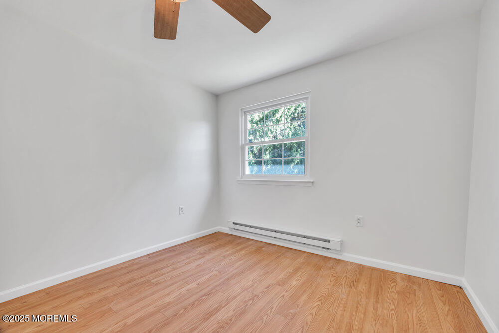 5B Spring Street, Unit B Whiting, NJ 08759 - Photo 17 of 39 an empty room with wooden floor and windows