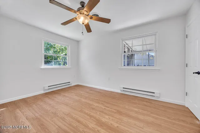 wooden floor in an empty room with a window