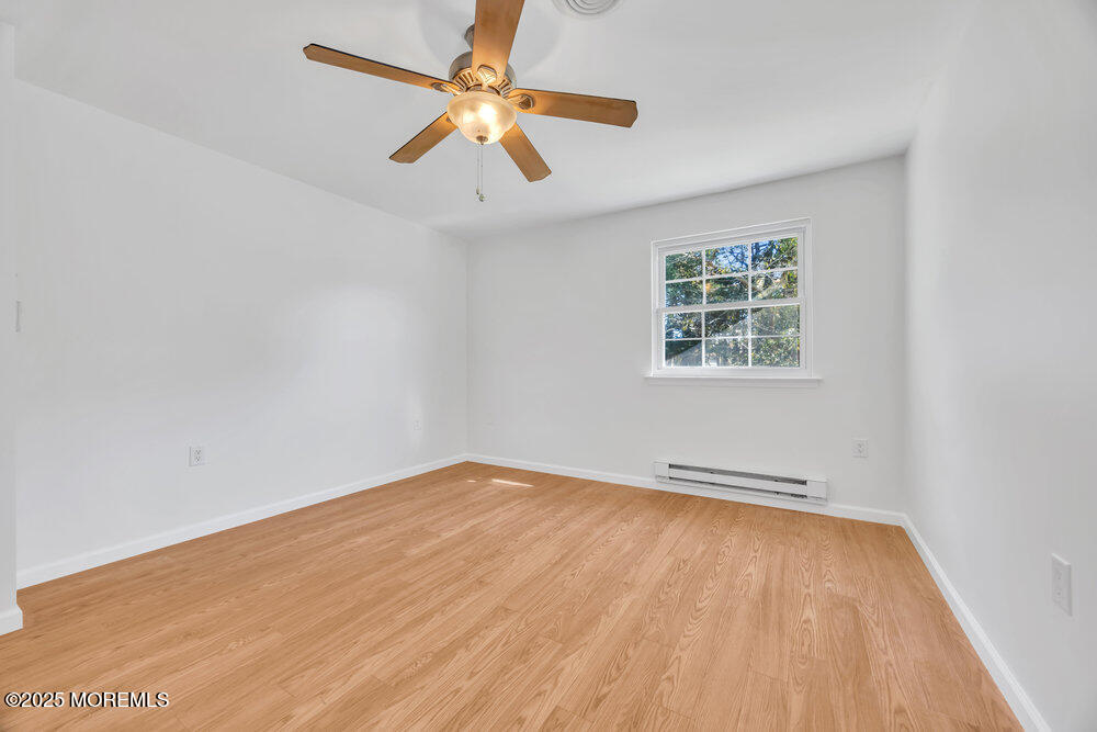 5B Spring Street, Unit B Whiting, NJ 08759 - Photo 20 of 39 an empty room with wooden floor and windows