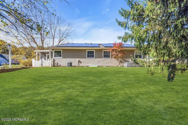 a front view of house with yard and green space