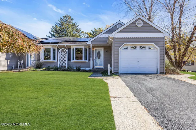 a front view of a house with a garden