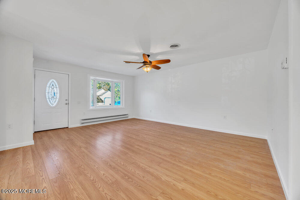 5B Spring Street, Unit B Whiting, NJ 08759 - Photo 9 of 39 an empty room with windows and cabinet