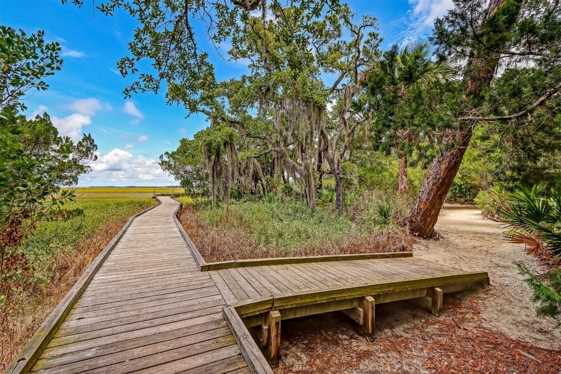 10 Sea Marsh Road Amelia Island, FL 32034 - Photo 75 of 78 a view of a wooden deck with a bench