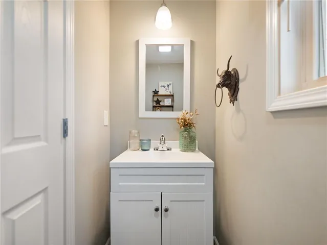 a bathroom with a sink mirror and vanity
