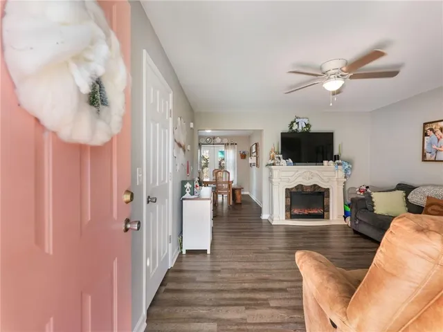 a living room with furniture a fireplace and a flat screen tv