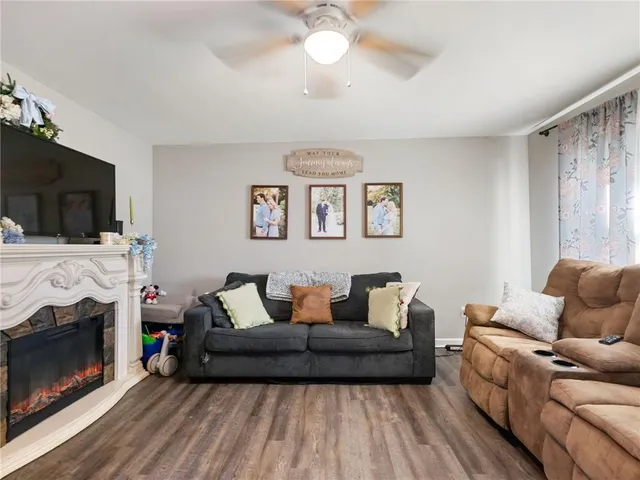 a living room with furniture a flat screen tv and a fireplace