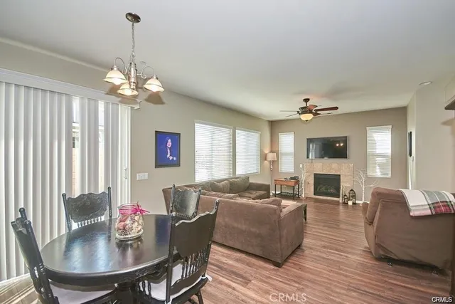a living room with furniture a chandelier and a flat screen tv