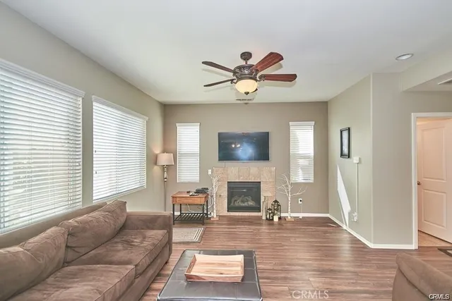 a living room with furniture a fireplace and a flat screen tv