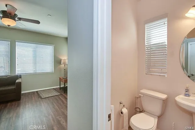 a bathroom with a toilet a sink and a window