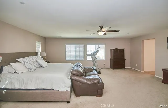 a spacious bedroom with a bed and window