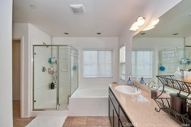 a spacious bathroom with a bathtub shower sink and mirror