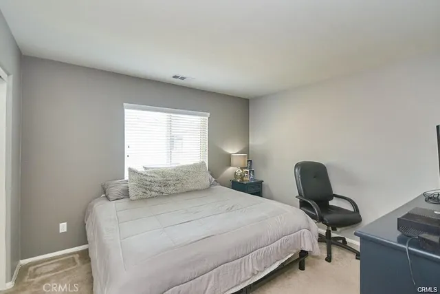 a bedroom with a bed and a chair