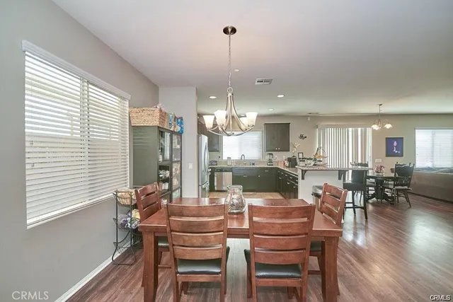 a dining room with furniture window and wooden floor