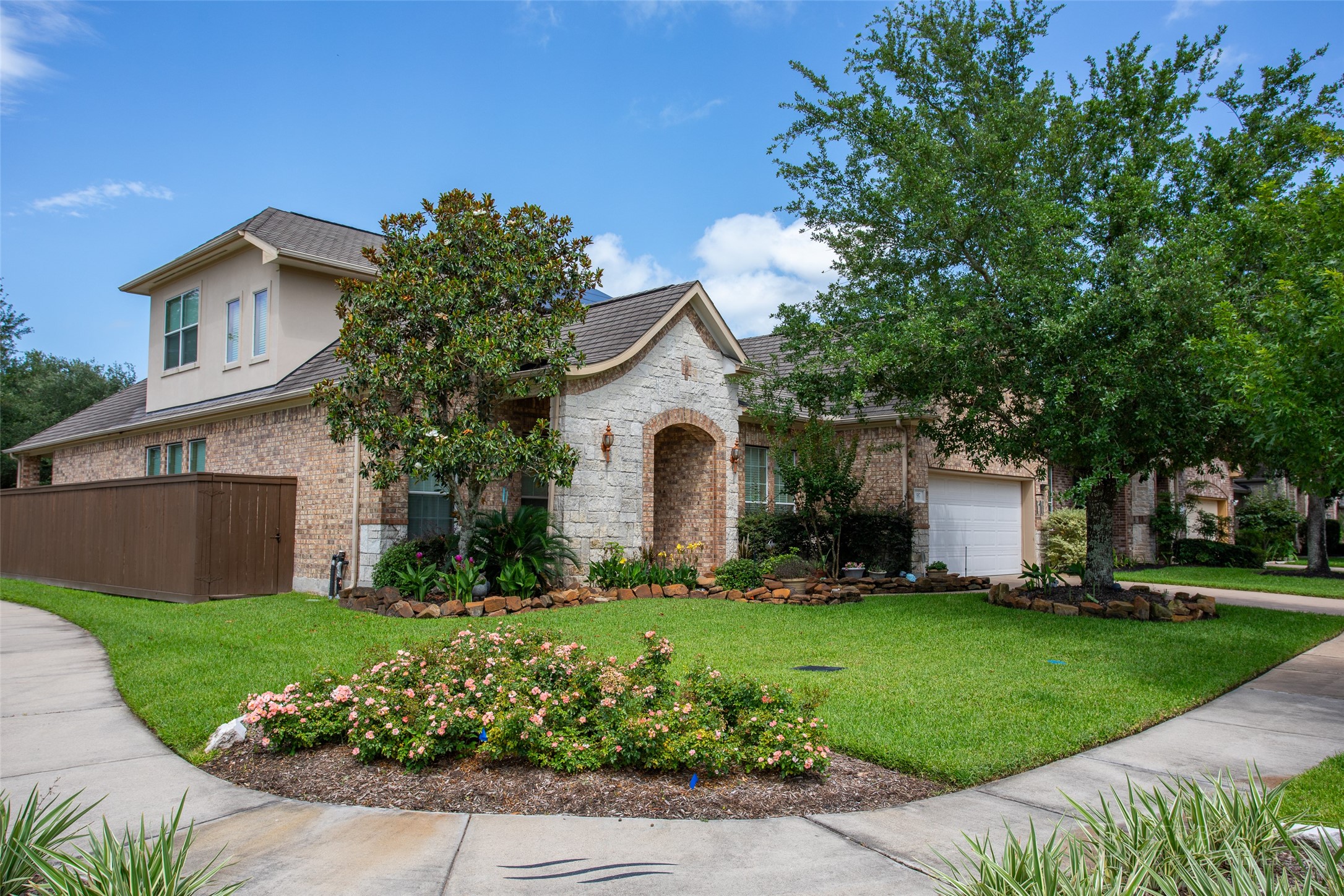 517 West Fork Webster, TX 77598 - Photo 1 of 28 a front view of a house with a garden