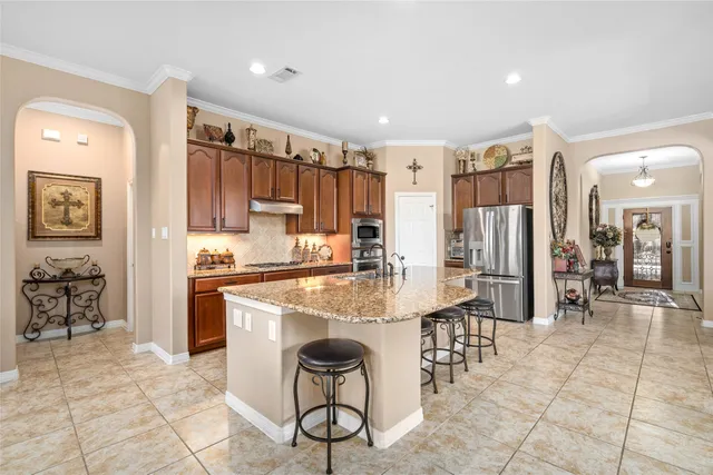 a kitchen with stainless steel appliances granite countertop a sink stove and cabinets