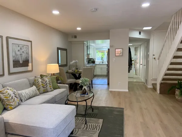 a living room with furniture and wooden floor