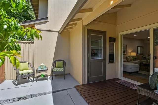 a view of a porch with furniture and a potted plant