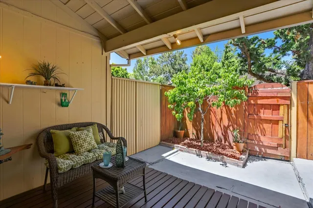 a view of a patio with table and chairs potted plants with wooden floor