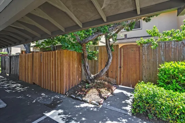 a view of a backyard with wooden fence