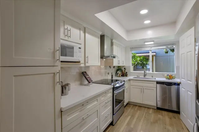 a kitchen with a sink appliances and cabinets