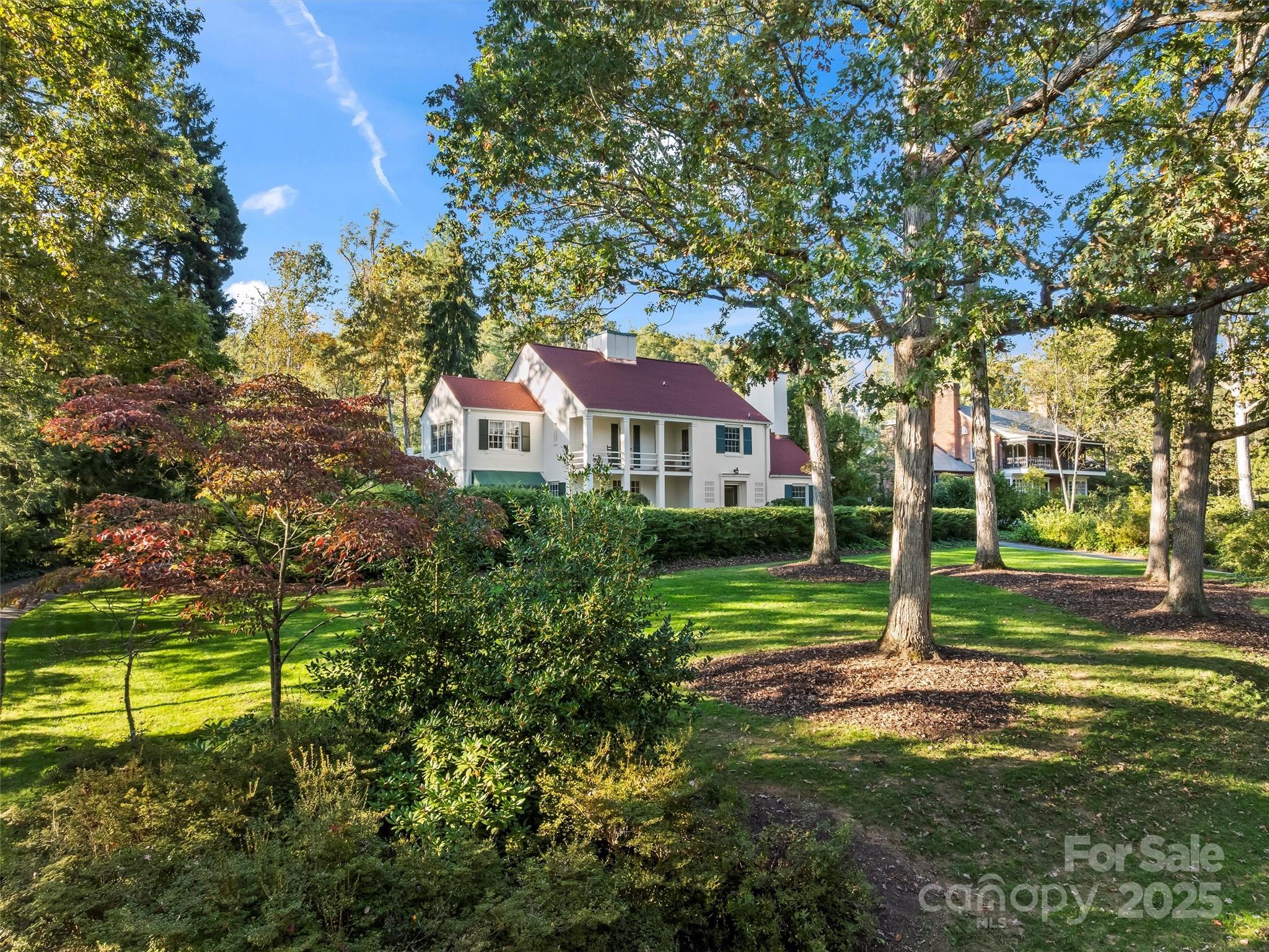 7 Park Road Asheville, NC 28803 - Photo 1 of 48 a view of a house next to a big yard and large trees